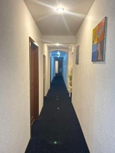 a corridor of a hallway with a long hallway at Hotel Adam in Berlin