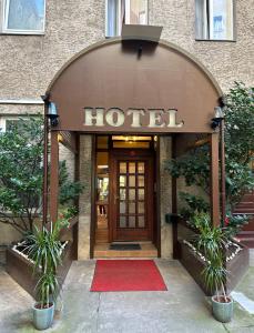 uma entrada do hotel com um tapete vermelho em frente em Hotel Adam em Berlim