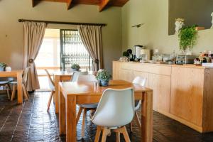 a dining room with a table and chairs at Agapé Boutique Guesthouse Bothaville in Bothaville