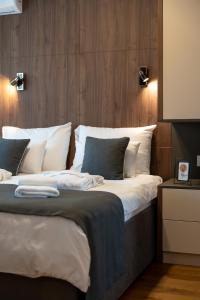 ein Schlafzimmer mit einem großen Bett mit weißen Kissen in der Unterkunft King's Square Lux apartment Zlatibor in Zlatibor