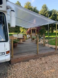awning over a wooden deck in front of a camper at The Bus Stop in Stokesley