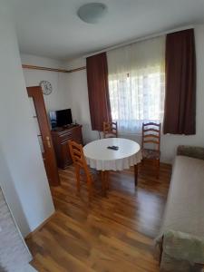 a living room with a white table and chairs at Guest house Kolasin in Kolašin