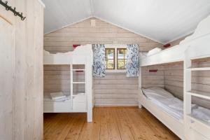 a room with two bunk beds and a window at First Camp Norsjø Telemark in Akkerhaugen