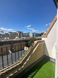 a balcony of a building with green grass on it at Home-like 1-BR flat in Victoria in London