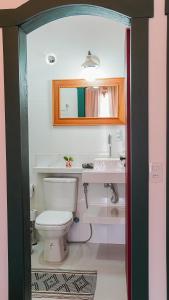 a bathroom with a toilet and a sink at Pouso da Rita - Tiradentes in Tiradentes