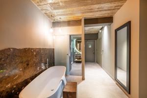 a bathroom with a bath tub and a mirror at Salini Suites in Żebbuġ +37 photos