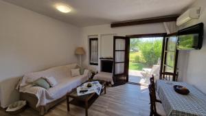 a living room with a couch and a table at Halkidiki, Family house to enjoy by the beach in Kalyves Poligirou