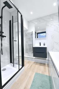 a white bathroom with a shower and a sink at North West London Escape in Mill Hill