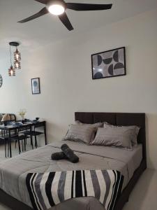 1 dormitorio con 1 cama y ventilador de techo en Senandika Homestay, en Kuching