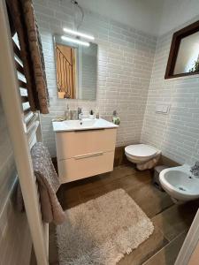 a bathroom with a sink and a toilet and a mirror at A un passo dal castello in Pacentro