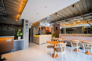 a restaurant with a table and chairs and a counter at KLM Condotel in Angeles
