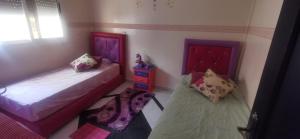 a bedroom with two beds and a dresser at alloggio in Agadir