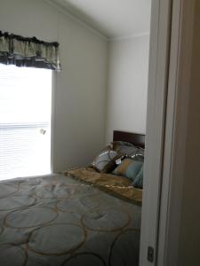 a bedroom with a bed and a window at Willow Bay RV Resort & Marina in Nine Mile Falls