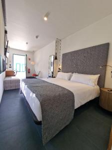 a large bedroom with a large bed in it at Hotel El Rosal de Cudillero in Cudillero