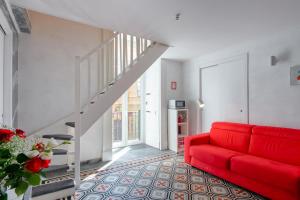 a red couch in a living room with a staircase at Enjoy Naples in Naples