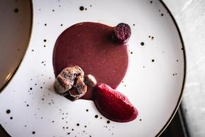 a white plate with a heart shaped dessert on it at Varbla sadam ja restoran Groot 