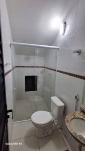 a bathroom with a shower and a toilet and a sink at SUITE STAR in Pau dos Ferros