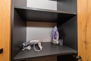 a room with a hair dryer on a shelf at MYFREEDOM Видові Апартаменти ВДНГ in Kyiv