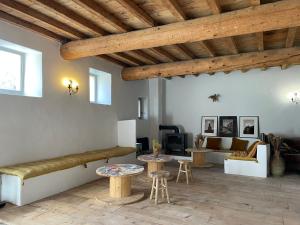 a living room with a couch and tables at Maison Tara verte au Mas Montredon in Arles