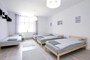 a room with four beds and a window at Apartament Piwna 13 in Gliwice