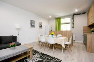 a living room with a table and chairs and a couch at Apartament Piwna 13 in Gliwice +11 photos