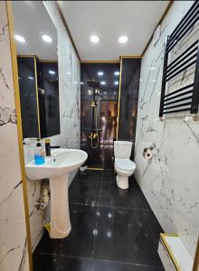 a bathroom with a sink and a toilet at Дом Лашо всё хорошо in Tbilisi City +35 photos
