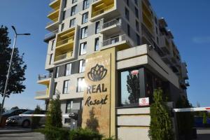 a building with a real estate sign in front of it at Real Residence -apartament cu 3 camere- Valeni 144 in Ploieşti