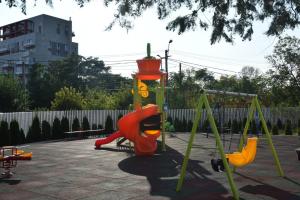 a playground with a slide and a swing set at Real Residence -apartament cu 3 camere- Valeni 144 in Ploieşti