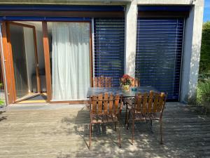 a table and chairs sitting on a porch with at Haus Elke in Hard