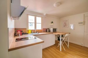 a kitchen with a sink and a counter top at Sweet Champagne - Centre-ville in Épernay +21 photos