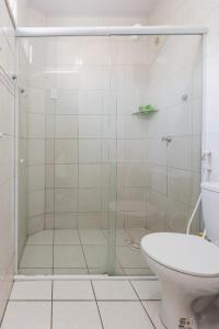 a bathroom with a glass shower with a toilet at Hotel Mares de Iracema in Fortaleza