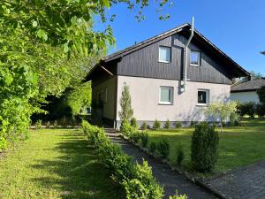 ein großes weißes Haus mit schwarzem Dach in der Unterkunft Ferienhaus Sternenhimmel in Thalfang