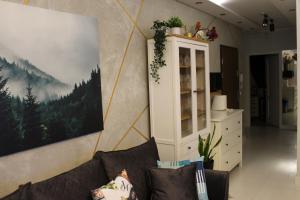 a living room with a couch and a cabinet at Apartament Euro 2 Kraków in Krakow