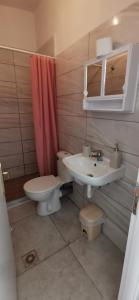 a bathroom with a toilet and a sink at Papatsas Center Houses in Nydri