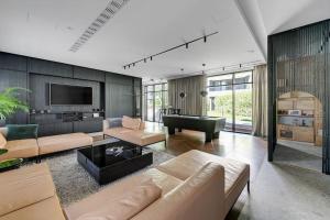 a living room with a couch and a piano at Portova Relax by Grand Apartments in Gdynia