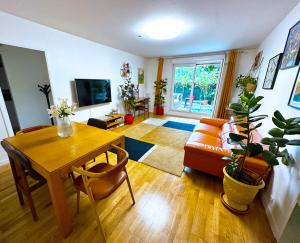 a living room with a table and a couch at Passion et détente by UTA HOUSE in Saint-Denis