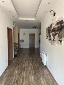 an empty hallway with wood floors and paintings on the walls at Residenz Zikeli 