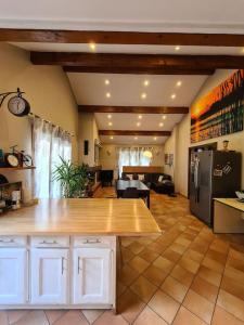 a kitchen with a wooden counter top in a room at Maison accessible à tous avec piscine! in La Tronche