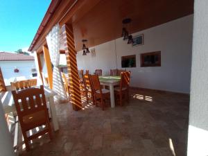 a dining room with a table and chairs at Pestele Ca Odinioară in Murighiol