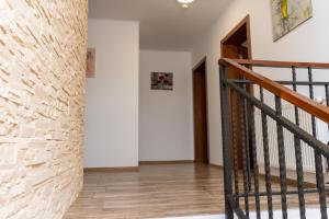 a staircase in a house with a brick wall at Residenz Zikeli 