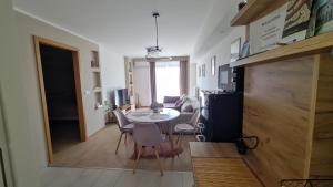 a living room with a table and chairs in a room at Riella Home in Szombathely