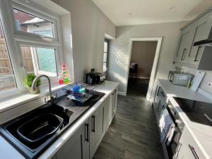 a kitchen with a sink and a counter top at Silver Stag Properties, 3 BR House in Ashby in Ashby de la Zouch