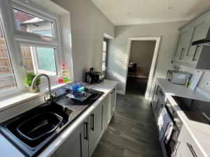 a kitchen with a sink and a counter top at Comfortable 3-BR Home Great Location in Ashby in Ashby de la Zouch
