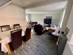 a living room with a table and a couch at Silver Stag Properties, 3 BR House in Ashby in Ashby de la Zouch