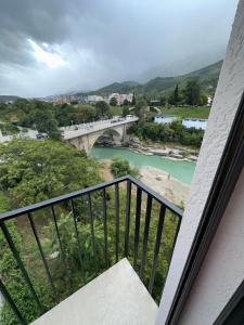 a balcony with a view of a river and a bridge at Hotel Trifoni in Përmet