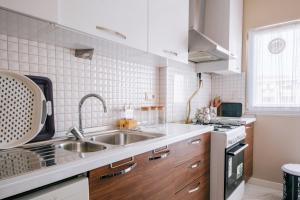 a kitchen with a sink and a stove at Lovely Flat w Balcony 10 min to Moda Coast in Istanbul