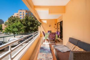 a balcony with furniture and a view of a city at Vilamoura Bay Retreat @ Marina Mar in Quarteira