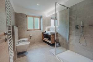 a bathroom with a shower and a toilet and a sink at Seeberhof - Urlaub am Bauernhof in San Giacomo +45 photos