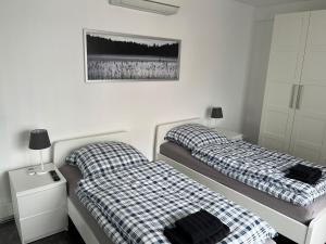 a bedroom with two beds and two night stands at Ferienwohnung bei Jennifer in Gütersloh