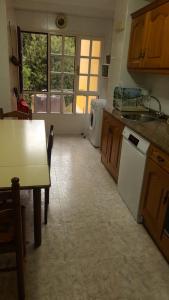 a kitchen with a table and a counter top at APARTAMENTO EN CANDAS CON GARAJE in Candás